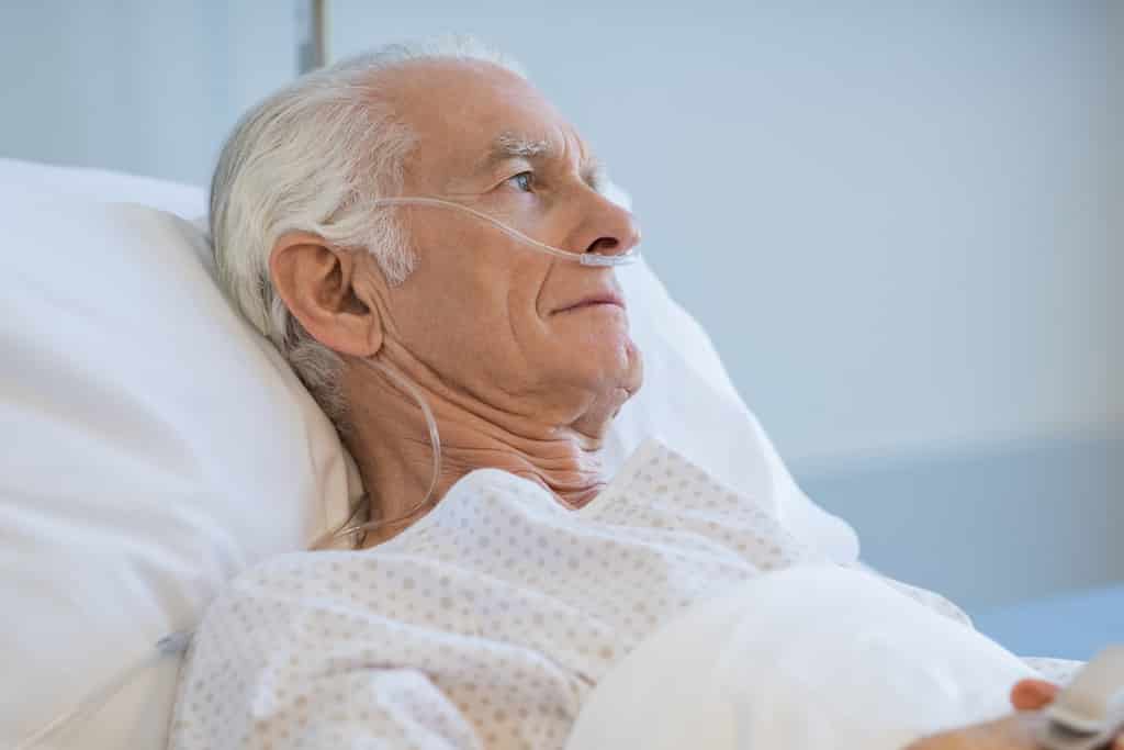 Elderly Man in Hospital Bed